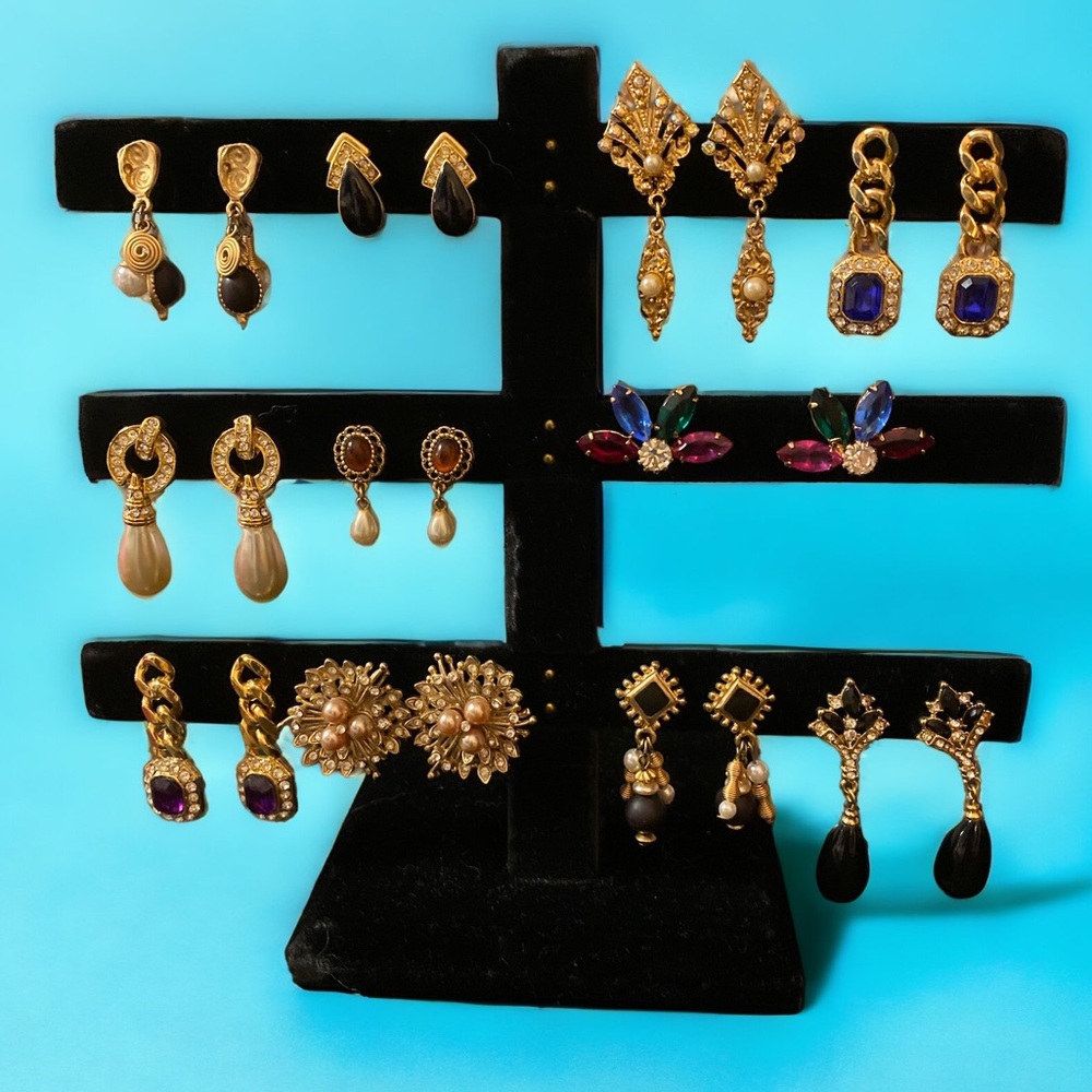 11 pairs of vintage gold tone earrings with various color gemstones
